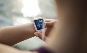 A closeup of a person looking at their smart watch for a pulse trace.